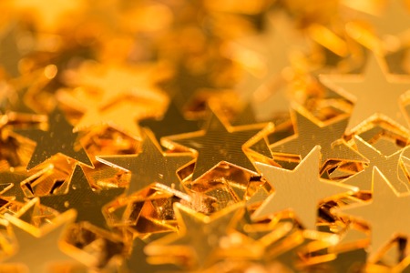 Christmas shiny little gold stars, close-up.の写真素材