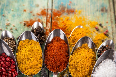 Various colorful spices of the world on wooden table, close-up.の写真素材