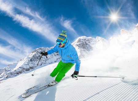 Skier skiing downhill in high mountainsの写真素材