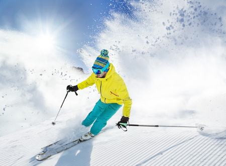 Skier skiing downhill in high mountainsの写真素材