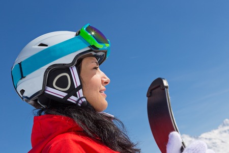 Beautiful brunette woman with skiの写真素材