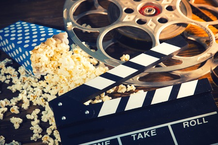 Cinema concept of vintage film reel with popcorn.の写真素材