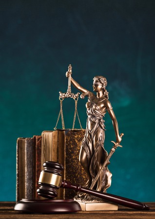 brown gavel with statue of justice.の写真素材