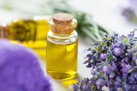 Wellness treatments with lavender flowers on wooden table.の写真素材