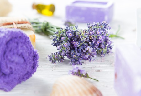 Wellness treatments with lavender flowers on wooden table.の写真素材