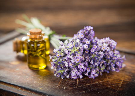 Wellness treatments with lavender flowers on wooden table.の写真素材