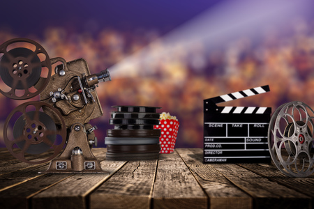 Cinema concept of vintage film reels, clapperboard and projector ond old wooden background.の写真素材