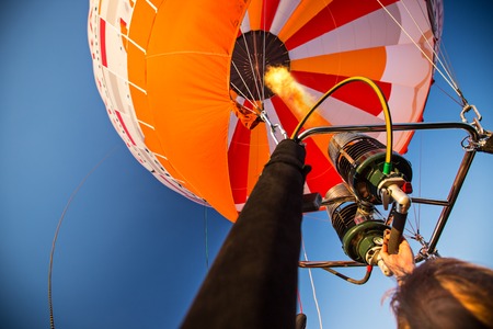 A hot air baloon rising high. Unusual perspective view.の写真素材