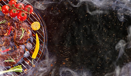 Barbecue grill with beef steaks, close-up.の写真素材