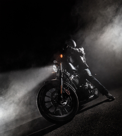 High power motorcycle chopper at night. Smoke effect on dark background.の写真素材