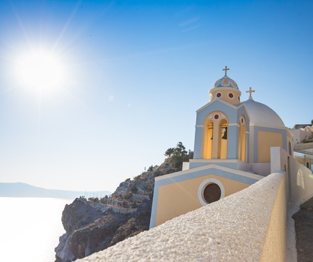 Beautiful yellow church dome on the edge of the town of Fira on Santorini island, Greece.の写真素材