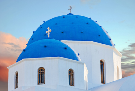 Classic view of blue dome church in Santorini. Oia Village, Greece.の写真素材