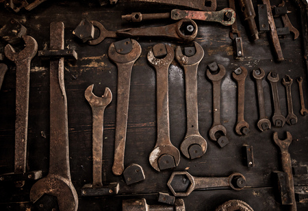 Dirty set of hand rtools on a wooden background Old rusty Equipment.の写真素材
