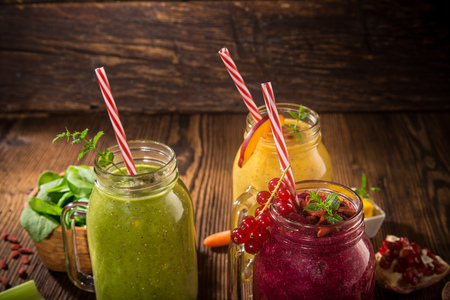 Healthy fresh smoothies with ingredients on old wooden table.の写真素材