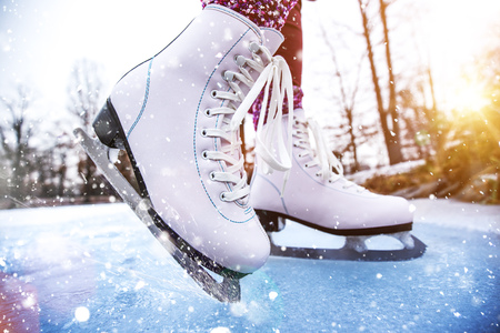 Close-up of woman ice skating on a pond on a freezing winter day