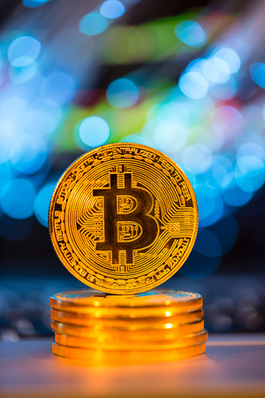 Bitcoin gold coins with defocused abstract background. Virtual cryptocurrency concept.の写真素材