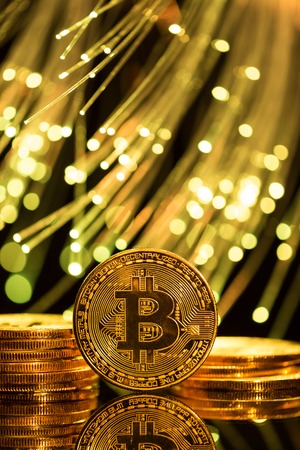Bitcoin gold coins with defocused abstract background. Virtual cryptocurrency concept.の写真素材