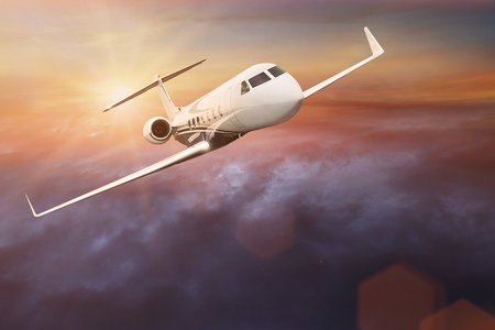 Commercial airplane flying above dramatic clouds.
