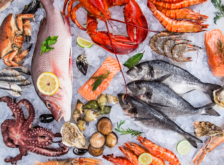 Fresh tasty seafood served on old wooden table. Top view. Close-up.の写真素材