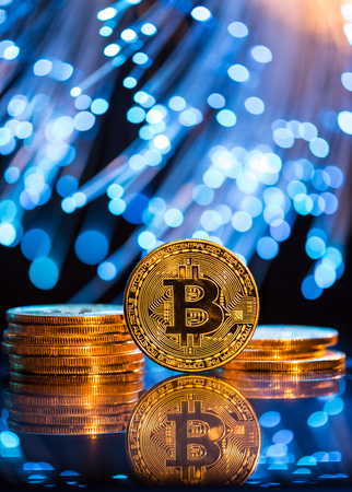 Bitcoin gold coin with defocused abstract background.