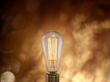 Vintage light bulb on dark background with empty space for text.の写真素材