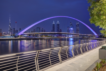 DUBAI, UAE - MAY 2018: Colorful sunset over Dubai Downtown skyscrapers and Tolerance bridge from the...