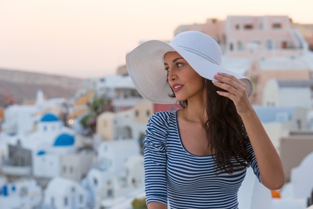 Santorini travel tourist brunette woman visiting famous white Oia village.の写真素材
