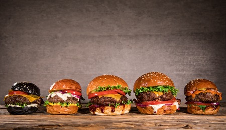 Tasty burgers on wooden table.の写真素材