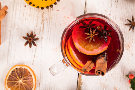 Christmas hot mulled wine with spices on wooden background.の写真素材