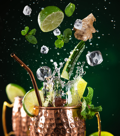 Famous splashing Moscow mule alcoholic cocktail in copper mugs.の写真素材