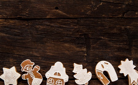 Christmas homemade gingerbread cookies on old wooden table.の写真素材