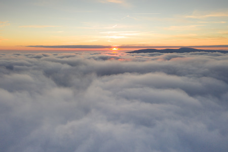 Sunset sky with beautiful clouds from the airplane windowの写真素材