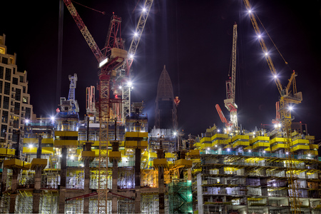 Building at construction process during night.