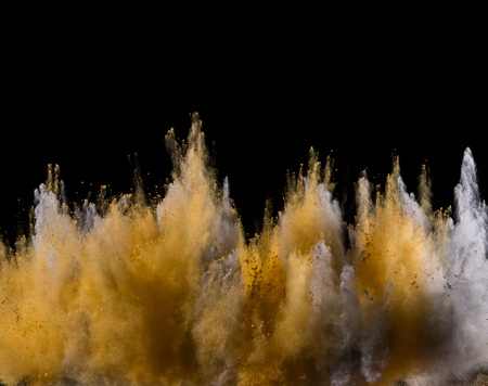 Colored powder explosion on blackの写真素材