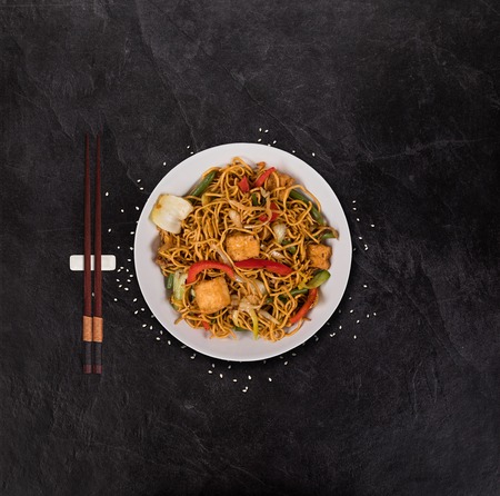 Vegetarian tofu asian food  with various ingredients on rustic stone table.