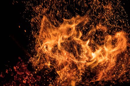 Burning sparks flying. Beautiful flames background.の写真素材