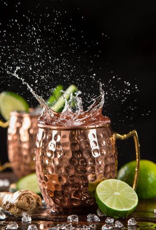 Famous splashing Moscow mule alcoholic cocktail in copper mugs.の写真素材