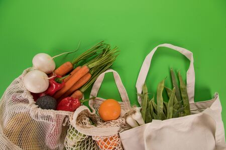 Fresh vegetables in bio eco cotton bags on old wooden table. Zero waste shopping concept.の写真素材