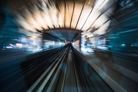Tran running on rails in a night city., blurred motion with light.の写真素材