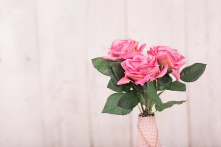 Flowers composition for Valentines, Mothers or Womens Day. Pink flowers on old white wooden background.の写真素材