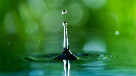 Macro shot of water drop over the water , relaxation with water ripple drops concept , freeze motionの写真素材