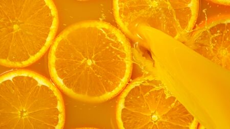 Freeze motion of pouring orange juice. Top view, close-up.の写真素材