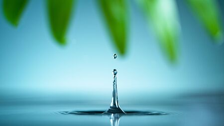 Macro shot of water drop over the water , relaxation with water ripple drops concept , freeze motionの写真素材