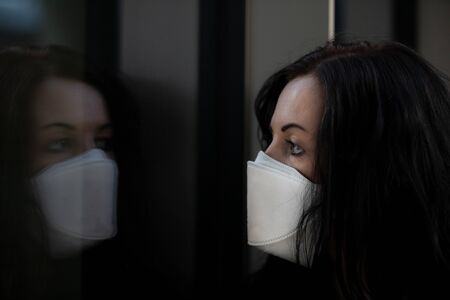 Woman in city with a face mask against infection