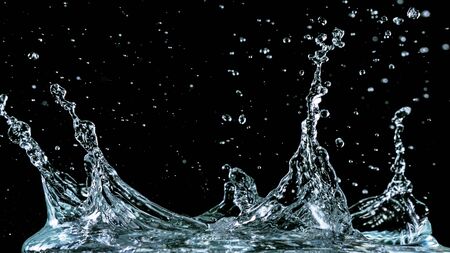 Water splash isolated on black backgroundの写真素材