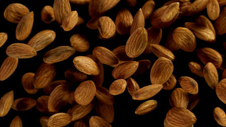 Flying almonds on black background