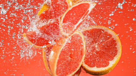 Fresh ripe grapefruits flying on a black background.の写真素材