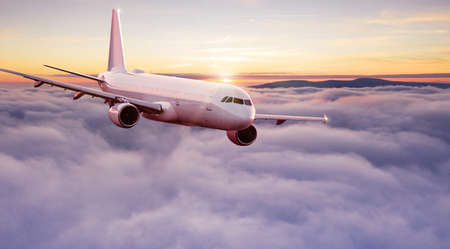 Commercial airplane jetliner flying above dramatic clouds.