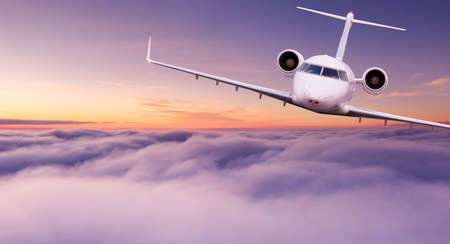 Small private jetplane flying above beautiful clouds.