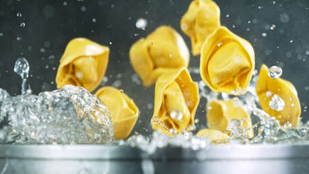 Throwing pasta into boiled waterの写真素材